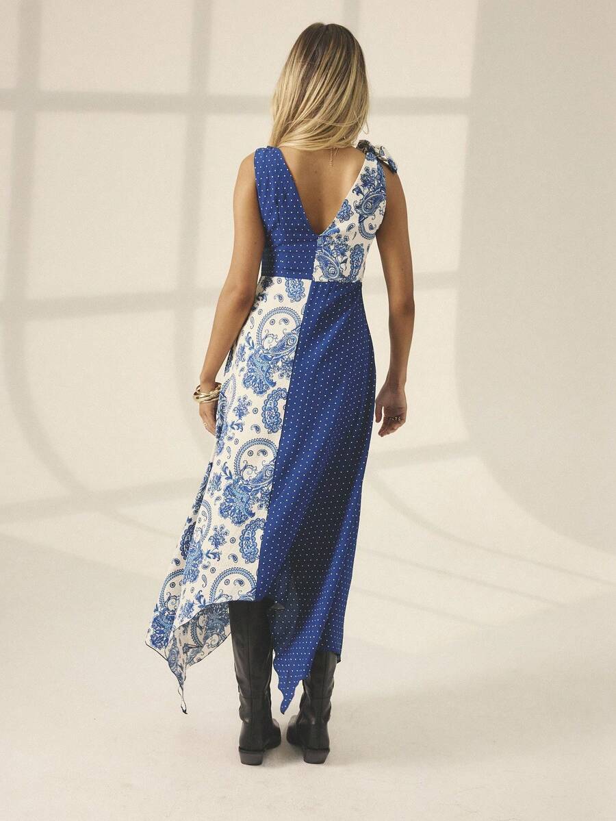 Elevate your fall-winter wardrobe with this stunning boho maxi dress. Featuring a flattering V-neckline, asymmetric hemline with slit, and high-waisted A-line silhouette, it effortlessly blends comfort with sophistication. The multicolor polka dot and floral print design brings playful elegance to weddings, celebrations, and special occasions. Crafted from a breathable woven fabric blend of 97% polyester and 3% elastane, this sleeveless beauty offers a slim fit that flatters your figure. Perfect for creatin