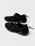 Rear-top view of black mesh water shoes with bungee toggles and textured rubber soles