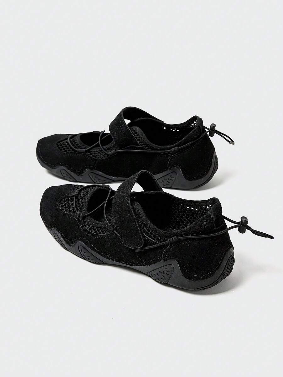 Rear-top view of black mesh water shoes with bungee toggles and textured rubber soles