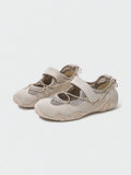 Front-quarter view of beige mesh water shoe with bungee toggle and textured rubber outsole