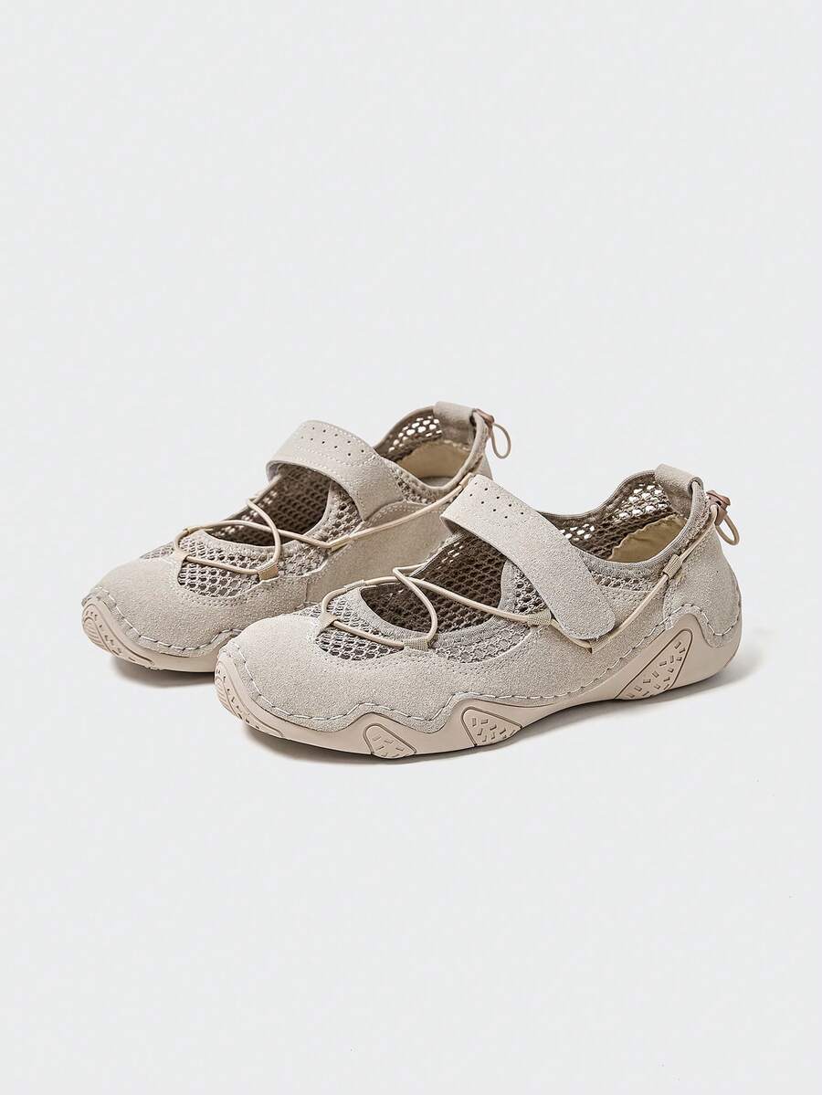 Front-quarter view of beige mesh water shoe with bungee toggle and textured rubber outsole