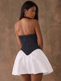 Back view of open-back denim halter mini dress with zipper and flared skirt