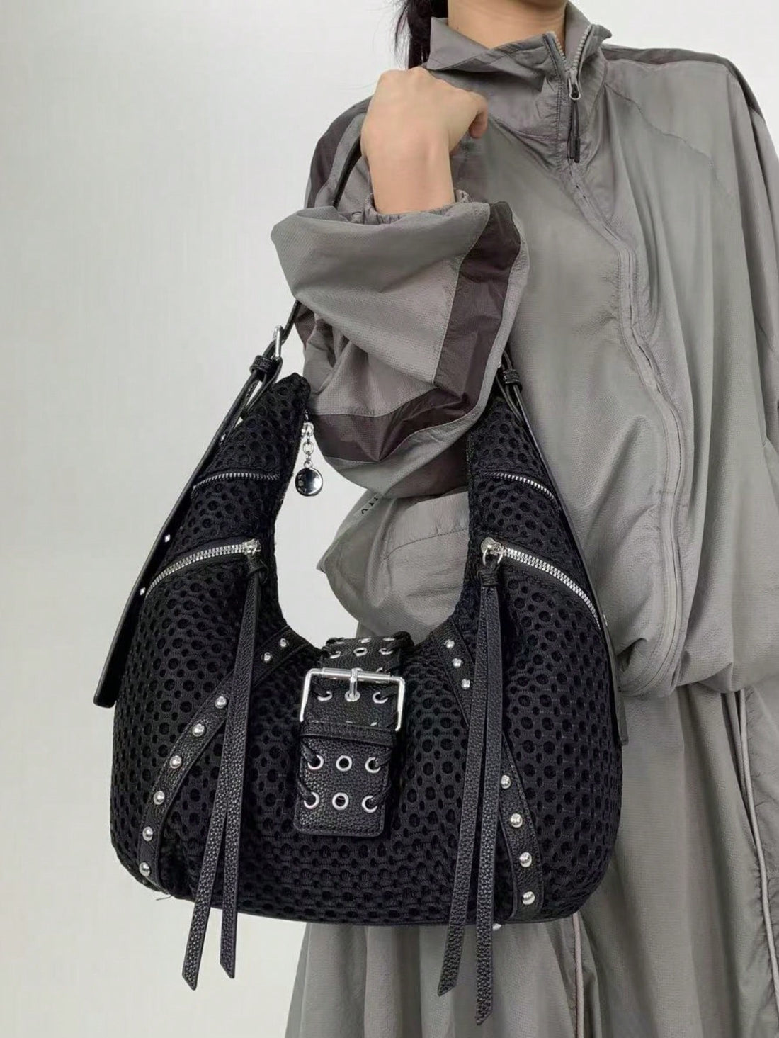 Add a playful pop to your look with this Y2K-inspired half moon shoulder bag. Packed with multiple zippers and adorned with chic tassel details, it keeps your essentials organized while turning heads. Perfect for everyday adventures, this bag combines retro flair with modern practicality for stylish fun on the go.