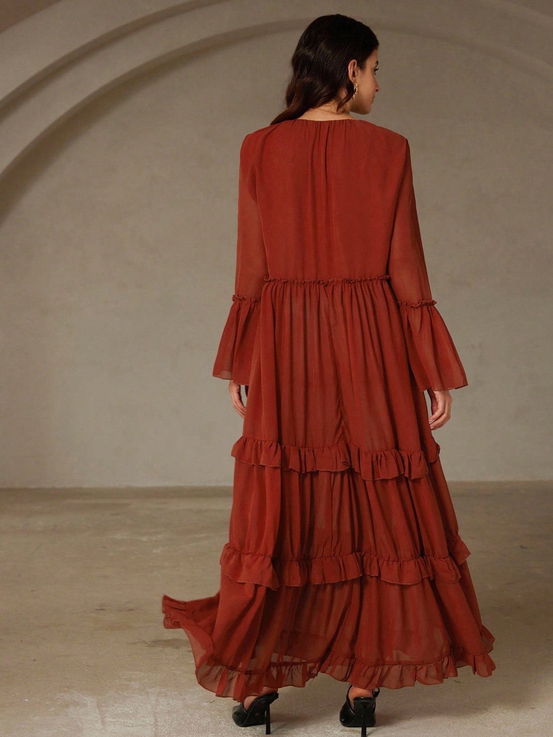 Step into fall with flair in this Brick Red Chiffon Dress! Featuring a daring deep V neckline, playful frill trim, and charming flare cuffs, it’s your new boho fave. Plus, the reversible design lets you switch up your look effortlessly, while the ruffled hem adds a flirty bounce with every step. Perfect for twirling through autumn days in style!