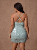 Back view of mint sequin mini dress with crisscross straps and zipper