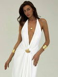 Close front view of white halter maxi dress with deep neckline and shell brooch