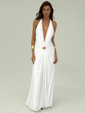 Front view of white backless halter maxi dress with metallic shell waist detail