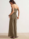 Back view of olive brown strapless jumpsuit with rear patch pockets and wide legs