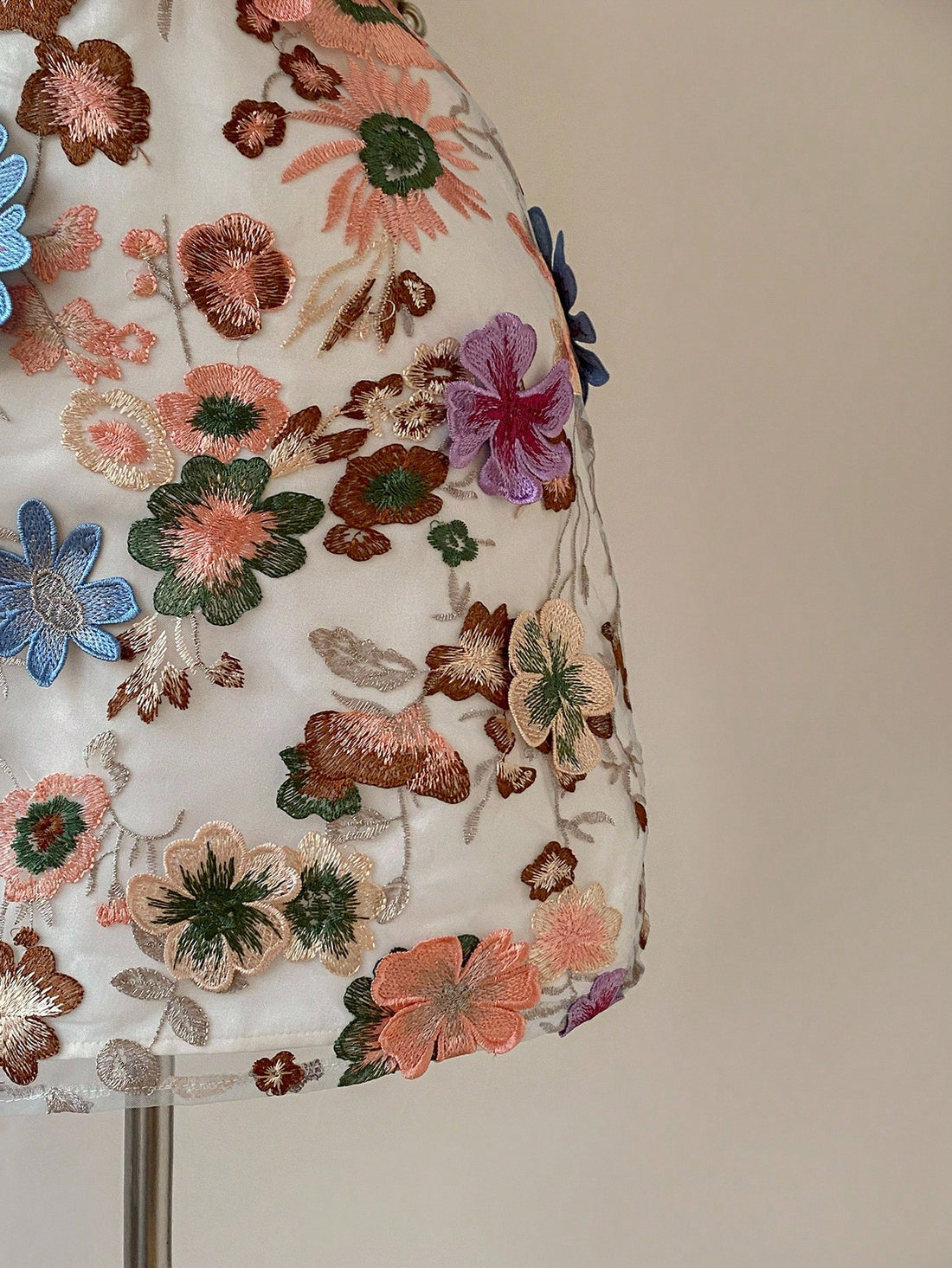 Step out in style with this playful mini dress featuring vibrant multi-color 3D mesh embroidery. Its adjustable criss-cross back lets you customize your fit, keeping you comfortable from day to night. Perfect for turning heads at any event, this dress combines fun design with effortless charm.