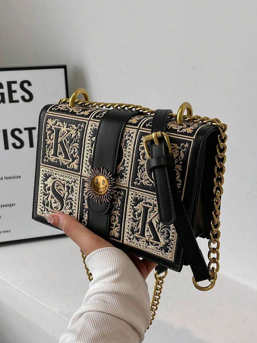 Black mini retro box crossbody bag with beige embroidery and gold chain strap