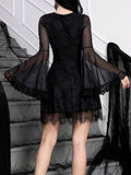 Back view of black rose-print mini dress showing sheer bell sleeves and lace hem