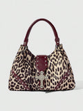 Close-up of sparkling silver cross hardware on patterned shoulder bag