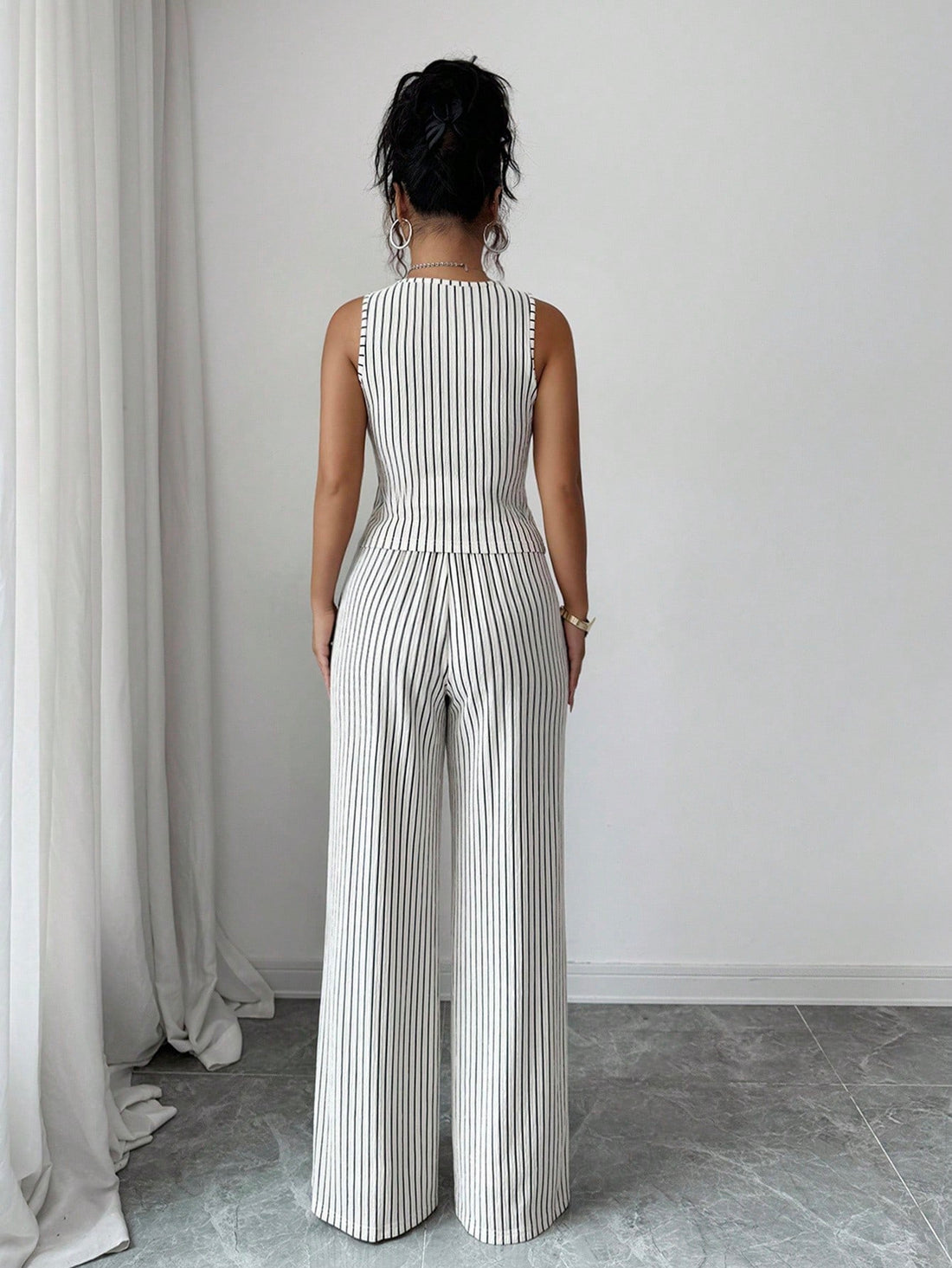 Elevate your everyday look with this chic two-piece set that's ready for anything! The sleeveless textured top pairs perfectly with high-waist pants, creating a polished silhouette that transitions seamlessly from office to weekend plans. The solid color design keeps things timeless while the textured fabric adds visual interest and dimension. Whether you're heading to a meeting or catching up with friends, this set delivers effortless elegance with a modern twist. Comfortable, versatile, and undeniably sty