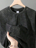 Close view of washed black crewneck T-shirt with size label detail