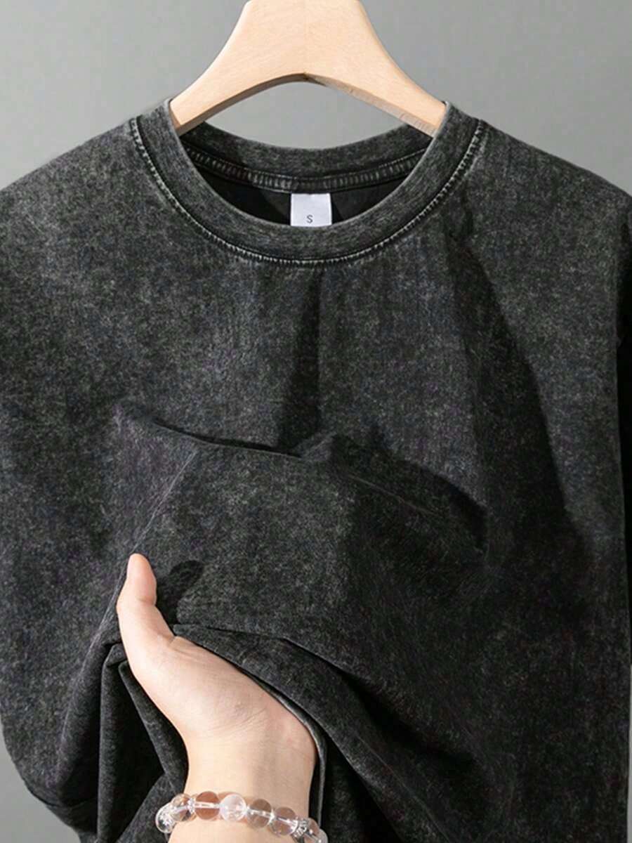 Close view of washed black crewneck T-shirt with size label detail