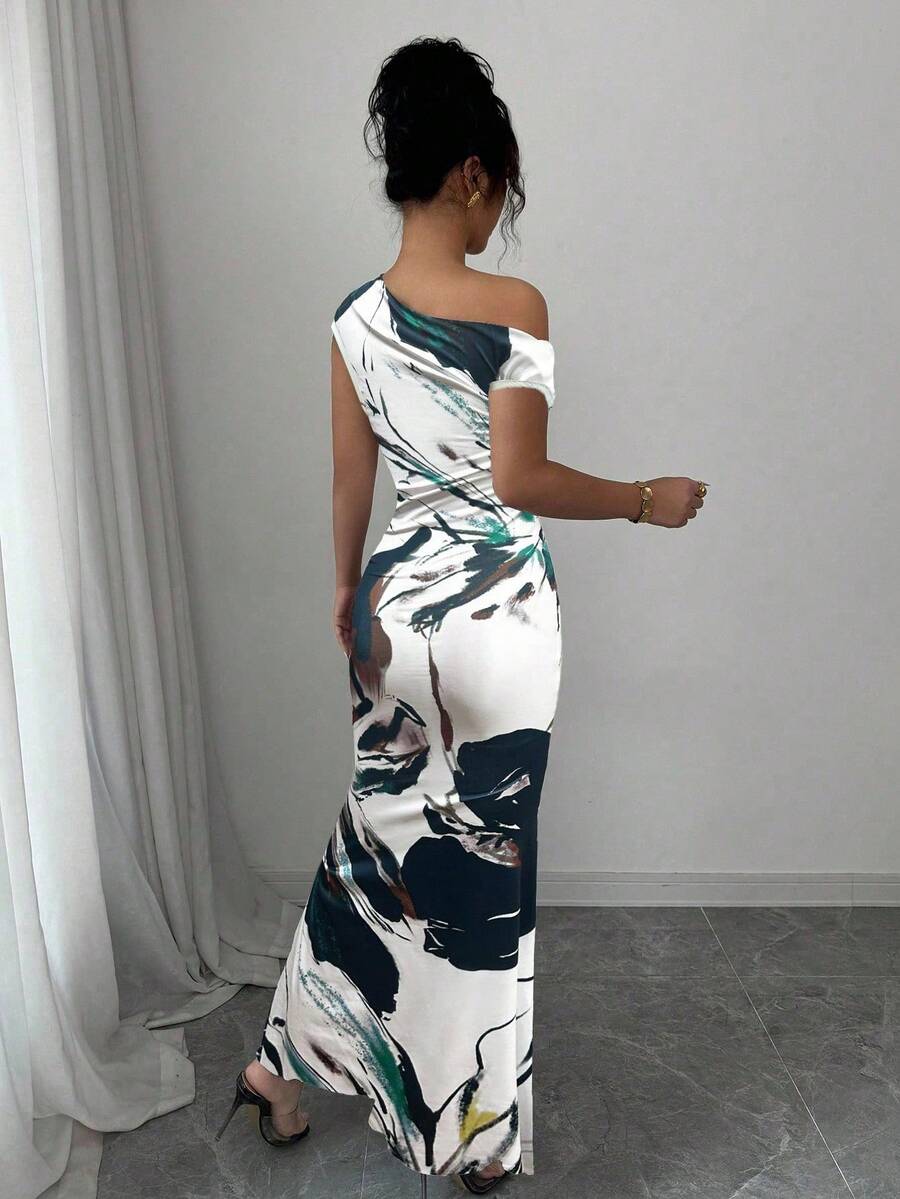 Turn heads at your next celebration in this stunning floral print fishtail dress. The asymmetric neckline adds an unexpected twist of elegance, while the dramatic fishtail hem creates a show-stopping silhouette perfect for summer weddings and holiday gatherings. Vibrant blooms dance across the fabric, bringing fresh, feminine charm to every occasion. Whether you're dancing under the stars or mingling at an outdoor soirée, this dress delivers effortless sophistication with a playful edge. A wardrobe essentia