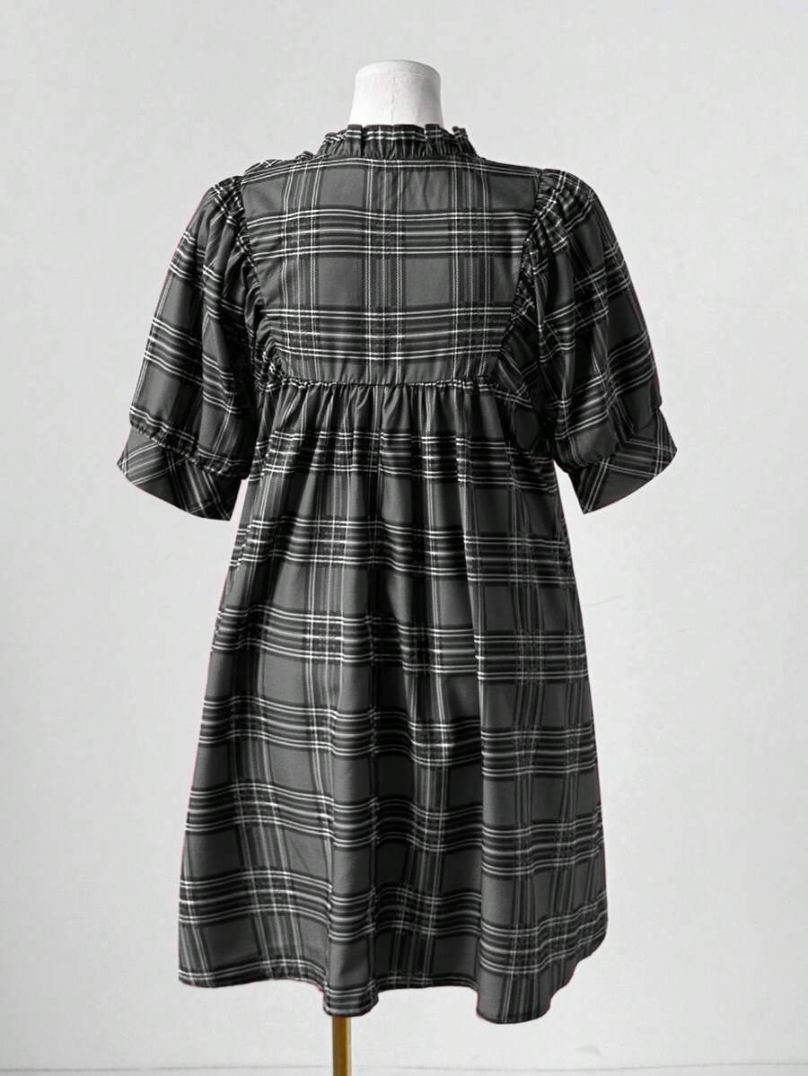 Step into timeless style with this charming plus-size plaid dress that brings vintage flair to your modern wardrobe. The flattering V-neckline pairs beautifully with delicate ruffle trim detailing, creating an effortlessly elegant silhouette. Perfect for anyone who loves retro-inspired fashion with a contemporary twist, this dress transitions seamlessly from casual outings to special occasions. Embrace your curves with confidence in a piece designed to celebrate your unique style and personality.
