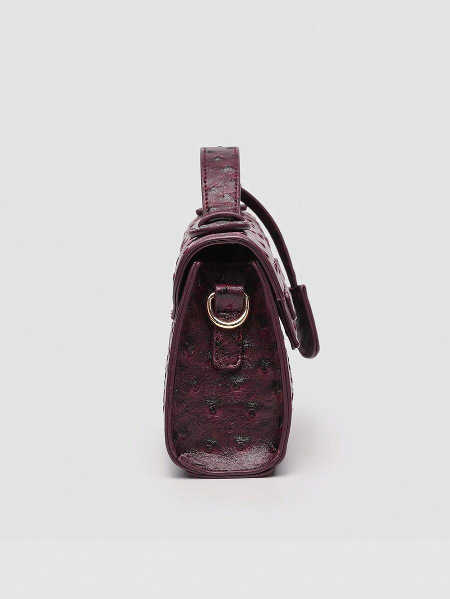 Ostrich embossed structured top handle shoulder bag with flap closure and adjustable strap