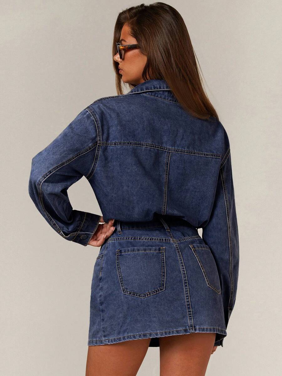 Front close view of washed blue denim shirt and mini skirt set with snap front and utility pockets
