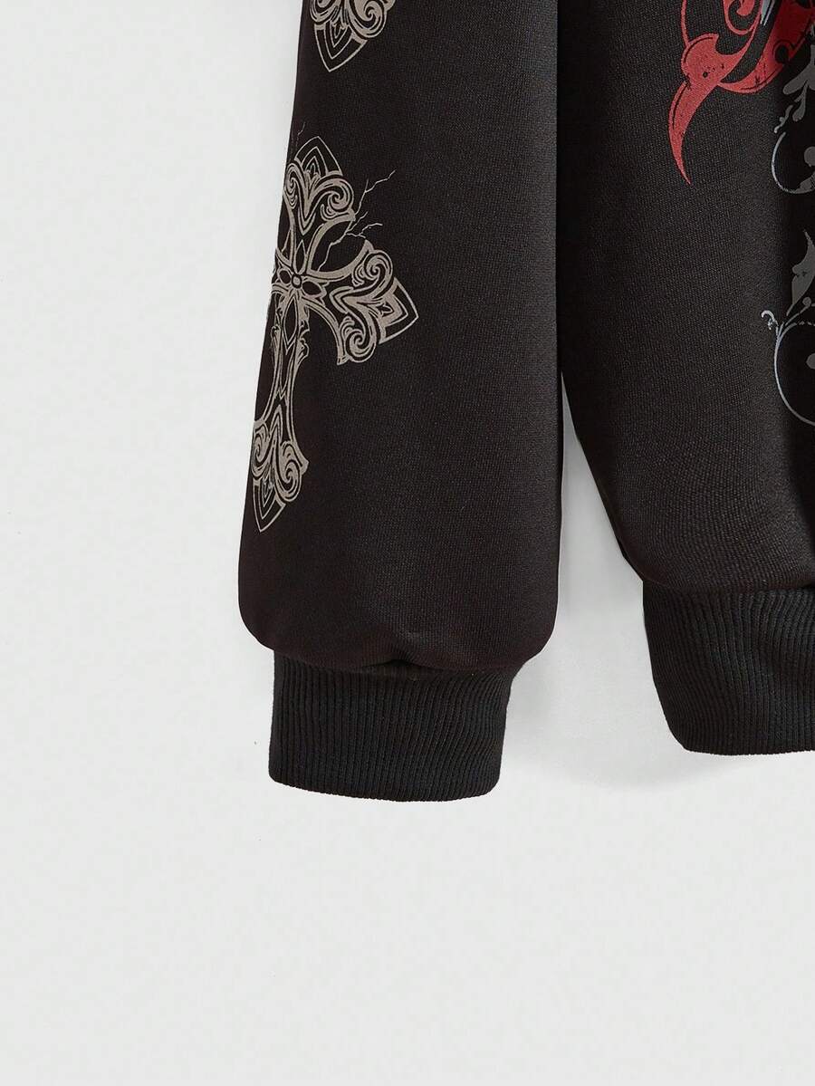 Close view of black hoodie ribbed cuff and cross graphic sleeve detail