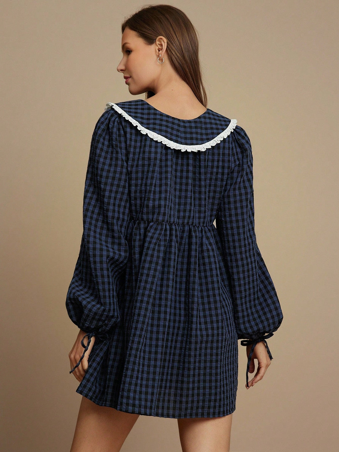 Gingham meets girly in this adorable babydoll mini dress that's giving major country concert vibes. The crisp eyelet detailing and charming collar add preppy polish, while the flowy silhouette keeps things breezy and fun. Whether you're dancing in the dirt or grabbing coffee with friends, this fall essential pairs perfectly with boots, sneakers, or sandals. It's the dress that makes you feel effortlessly cute without even trying.