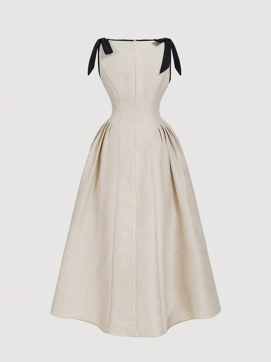 Slip into timeless elegance with this navy blue sleeveless dress that's anything but boring. Crisp contrast trim frames the neckline and armholes, while a charming bow detail adds a touch of personality. The flared hem swings with every step, creating a flattering silhouette that works from brunch to evening plans. Perfect for those days when you want to look put-together without trying too hard. A wardrobe essential that proves simple can be seriously stylish.