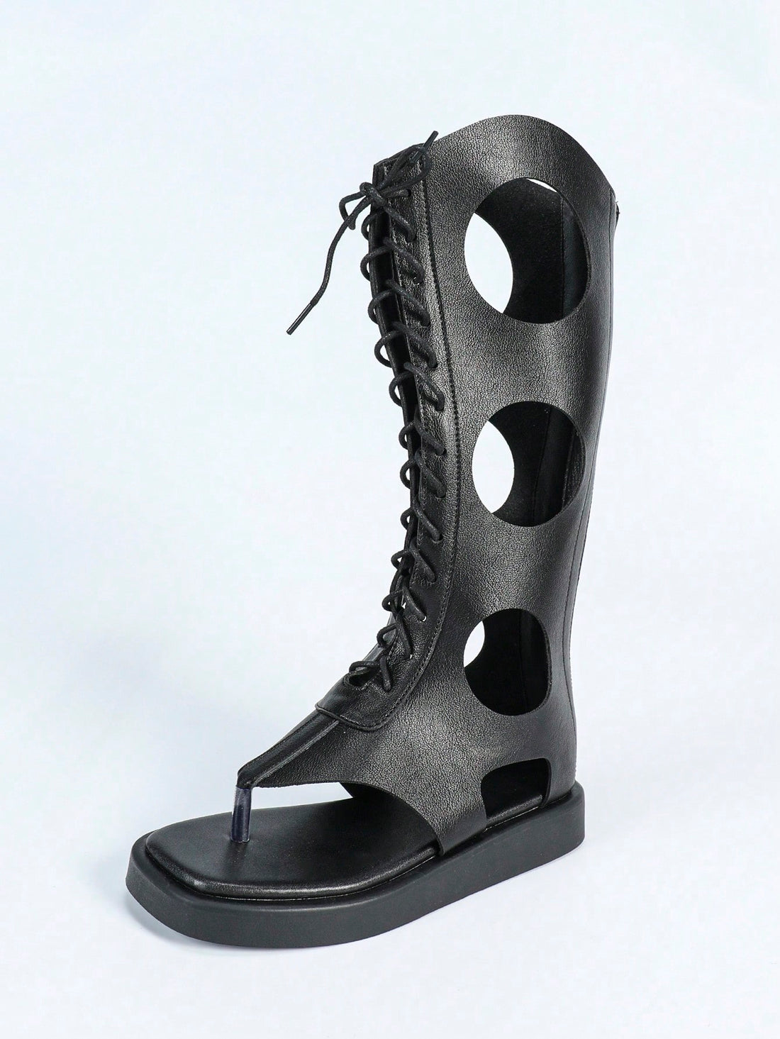 Step into timeless elegance with these Roman-inspired flat sandals, designed for the modern woman who values both style and comfort. The distinctive square toe thong silhouette offers a contemporary twist on a classic design, while the adjustable lace-up back ensures a customized fit. A convenient zipper closure adds practicality to this sophisticated piece. Crafted in sleek black, these sandals transition effortlessly from casual daytime wear to evening occasions, making them an essential addition to any v