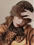 Close-up of model wearing plush leopard-print hat and scarf set