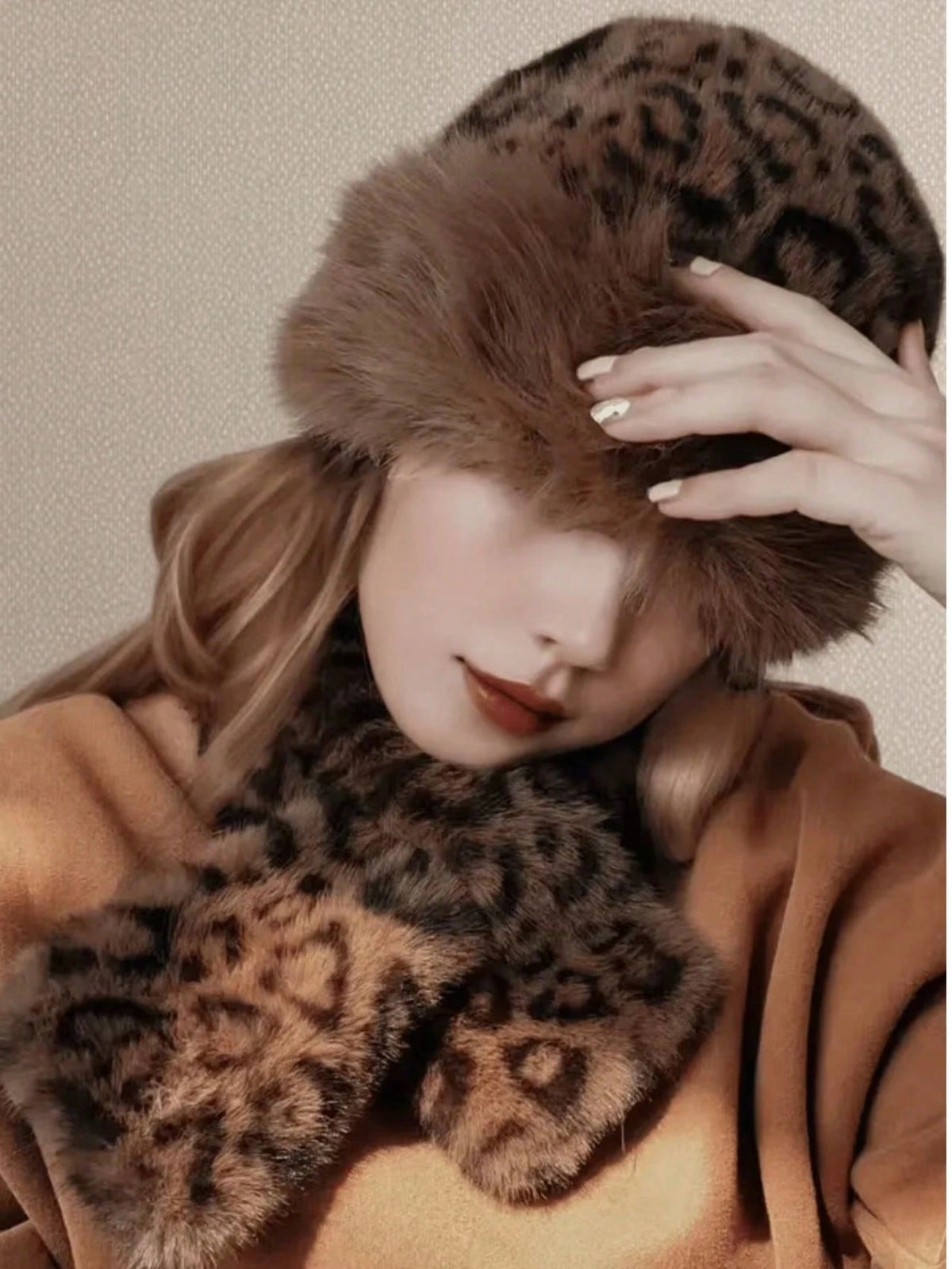 Close-up of model wearing plush leopard-print hat and scarf set