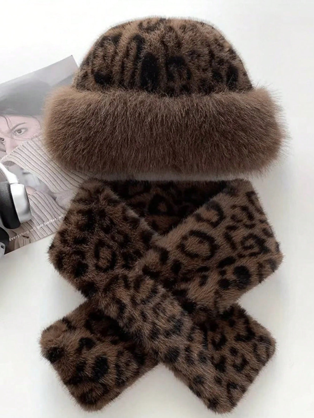 Model wearing brown leopard faux-fur brimmed hat and matching scarf