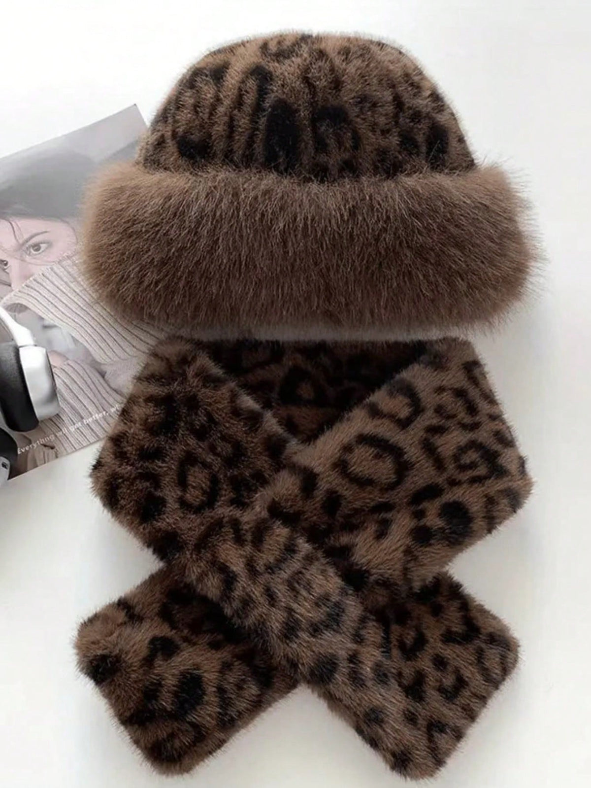Flat lay of matching brown leopard faux-fur hat and long scarf
