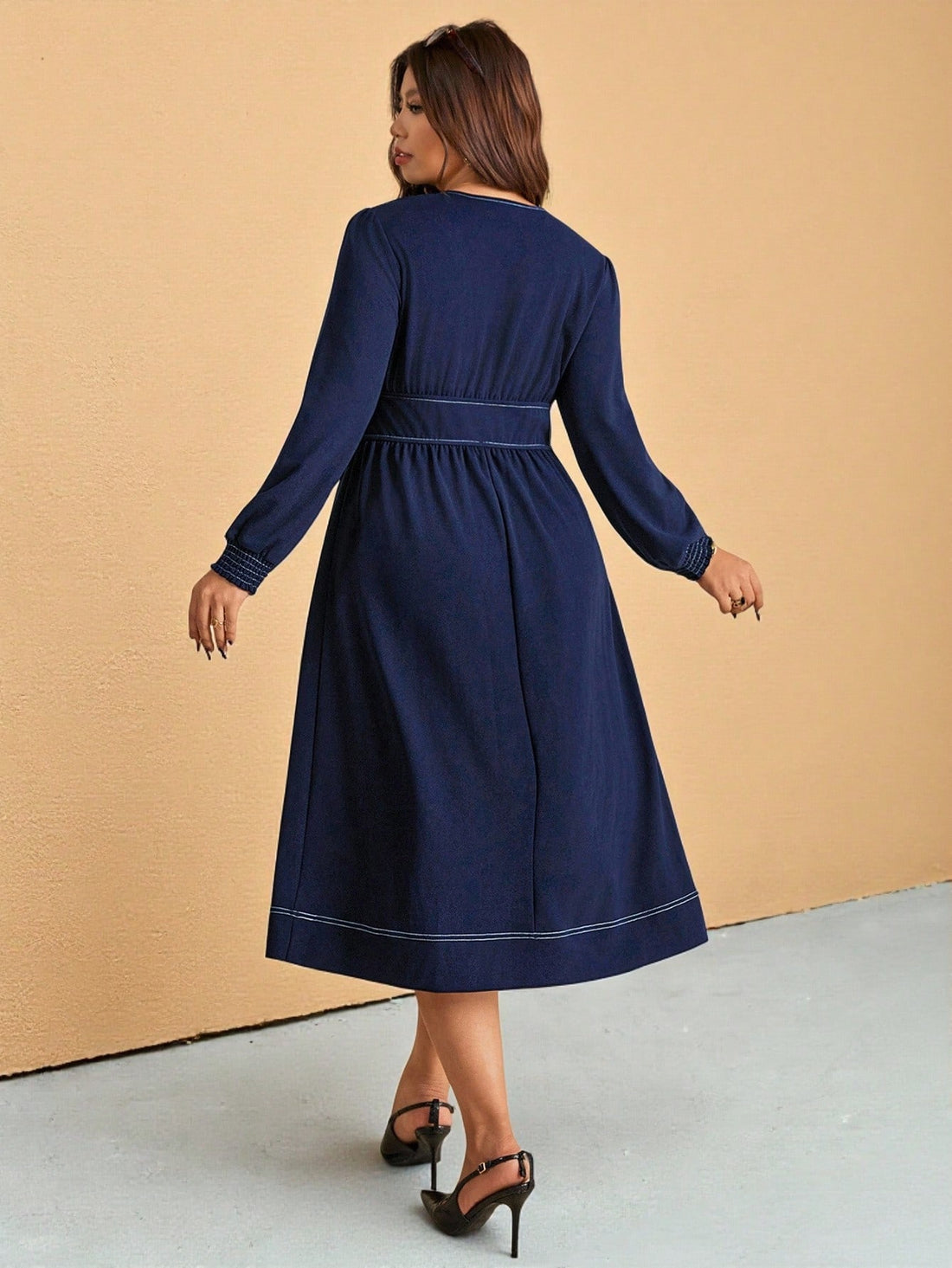 Turn heads with this chic plus-size dress designed for comfort and flair. Its flattering V-neck and long sleeves offer a perfect balance between casual and classy, making it your go-to for effortless elegance. The solid color keeps it versatile, easily dressed up or down to match your mood. Slip into style with ease and feel fabulous all day long!