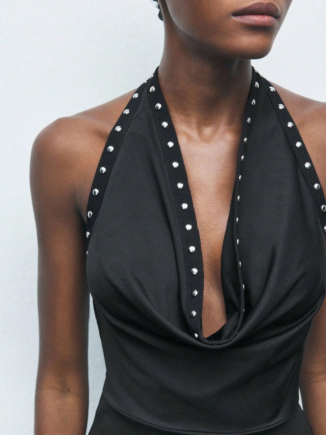 This sleek black knit dress features a daring plunging neckline, blending elegance with a hint of sass. Perfect for Halloween parties, New Year celebrations, or wedding guests looking to make a chic entrance. Flattering and comfortable, it’s your go-to piece to turn heads and keep the good vibes flowing all night long.