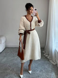 Front view of cream and brown belted polo collar knit midi dress with bishop sleeves and button front