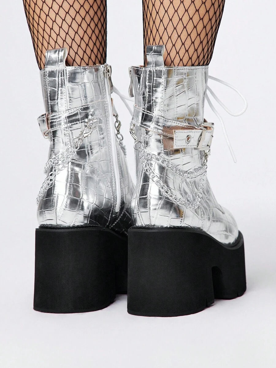 Step into bold style with these Gothic Grunge Punk Chunky Heel Ankle Boots, where edgy attitude meets everyday wearability. Featuring a sturdy platform wedge and metal chain accents, these combat-inspired boots deliver serious attitude without sacrificing comfort. The chunky heel provides stability while the padded construction keeps your feet happy through long days of making a statement. Perfect for anyone ready to embrace their darker, more rebellious side—whether you're channeling grunge vibes or full-o