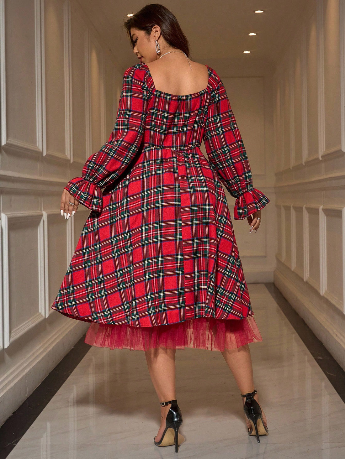Elevate your holiday wardrobe with this stunning plus-size plaid dress, featuring elegant black and red patchwork design. The square neckline and flare sleeves create a sophisticated silhouette, while contrast mesh panels and ruffled hem add modern flair. Perfect for Christmas parties and formal occasions, this midi bodycon dress combines timeless elegance with contemporary style. Crafted from 100% polyamide woven fabric with semi-sheer mesh details, it's designed for a flattering regular fit. Machine washa
