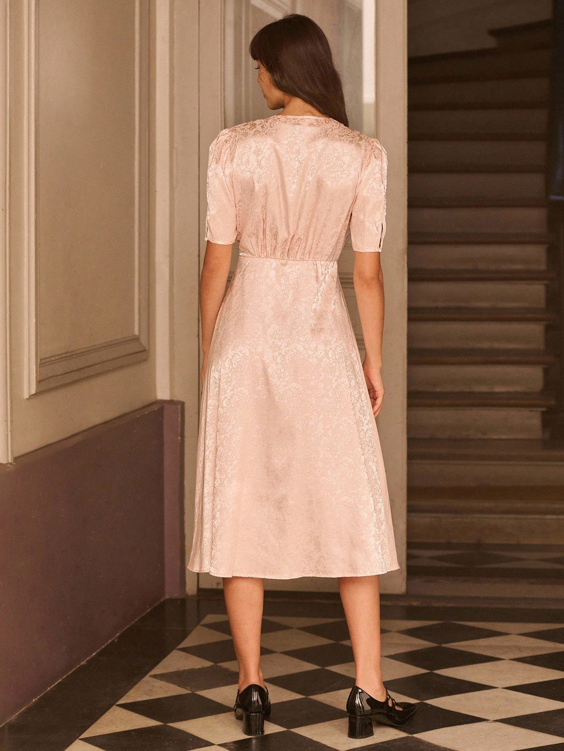 Step into autumn elegance with this charming vintage-inspired midi dress that effortlessly blends sophistication with whimsy. Crafted in luxurious pink satin, it features delicate floral detailing and a polished button front that adds just the right touch of business-casual flair. The midi length offers timeless appeal while the soft, flowing fabric drapes beautifully for all-day comfort. Perfect for transitioning from office to evening plans, this dress proves that vintage charm never goes out of style.
