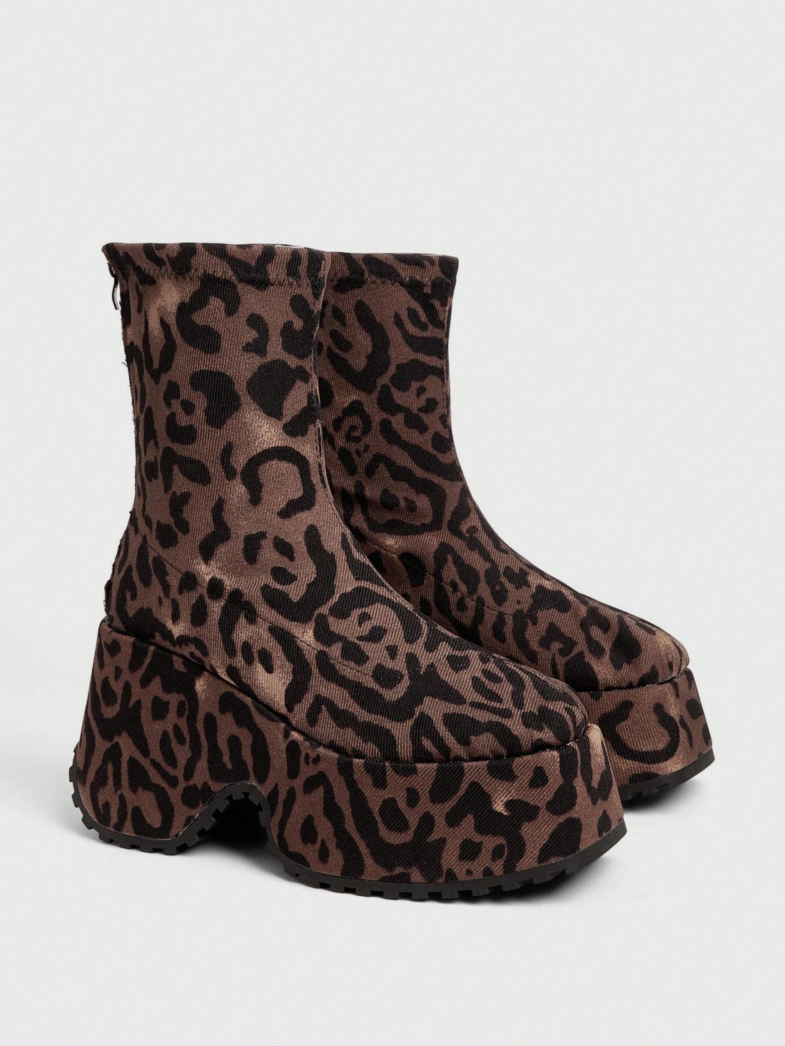 Step into the future with these bold Y2K platform boots that scream attitude. Featuring a chunky sole and asymmetric heel design, these black punk-inspired ankle boots deliver maximum edge with every stride. Perfect for channeling your inner goth aesthetic or adding rebellious flair to any outfit. Whether you're hitting the club or making a statement on the street, these boots command attention and refuse to blend in. Unapologetically bold, undeniably cool.