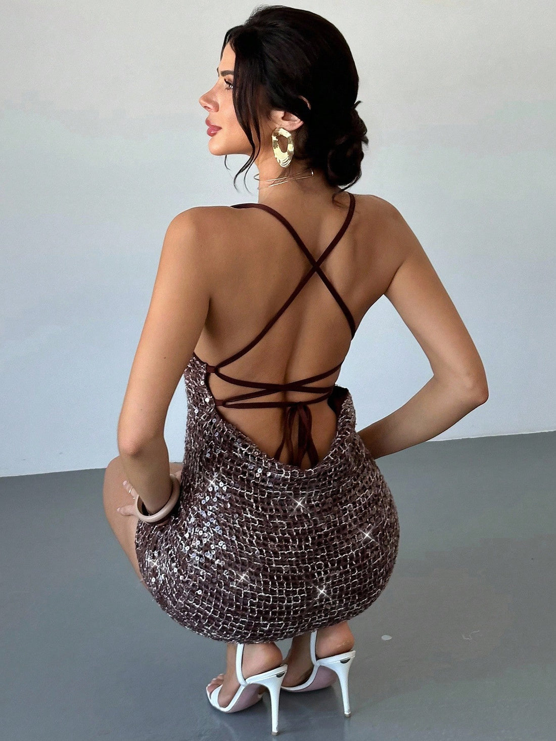 Turn heads wherever you go with this Coffee Brown Deep V-Neck Sequin Mini Dress. Its sparkling sequins catch the light for unforgettable nightlife vibes, while the flirty mini length and plunging neckline add just the right amount of sass. Perfect for dancing the night away at clubs, making memories on vacation, or standing out at special events, this dress makes every moment a celebration of your style. Slip it on and let your confidence shine!