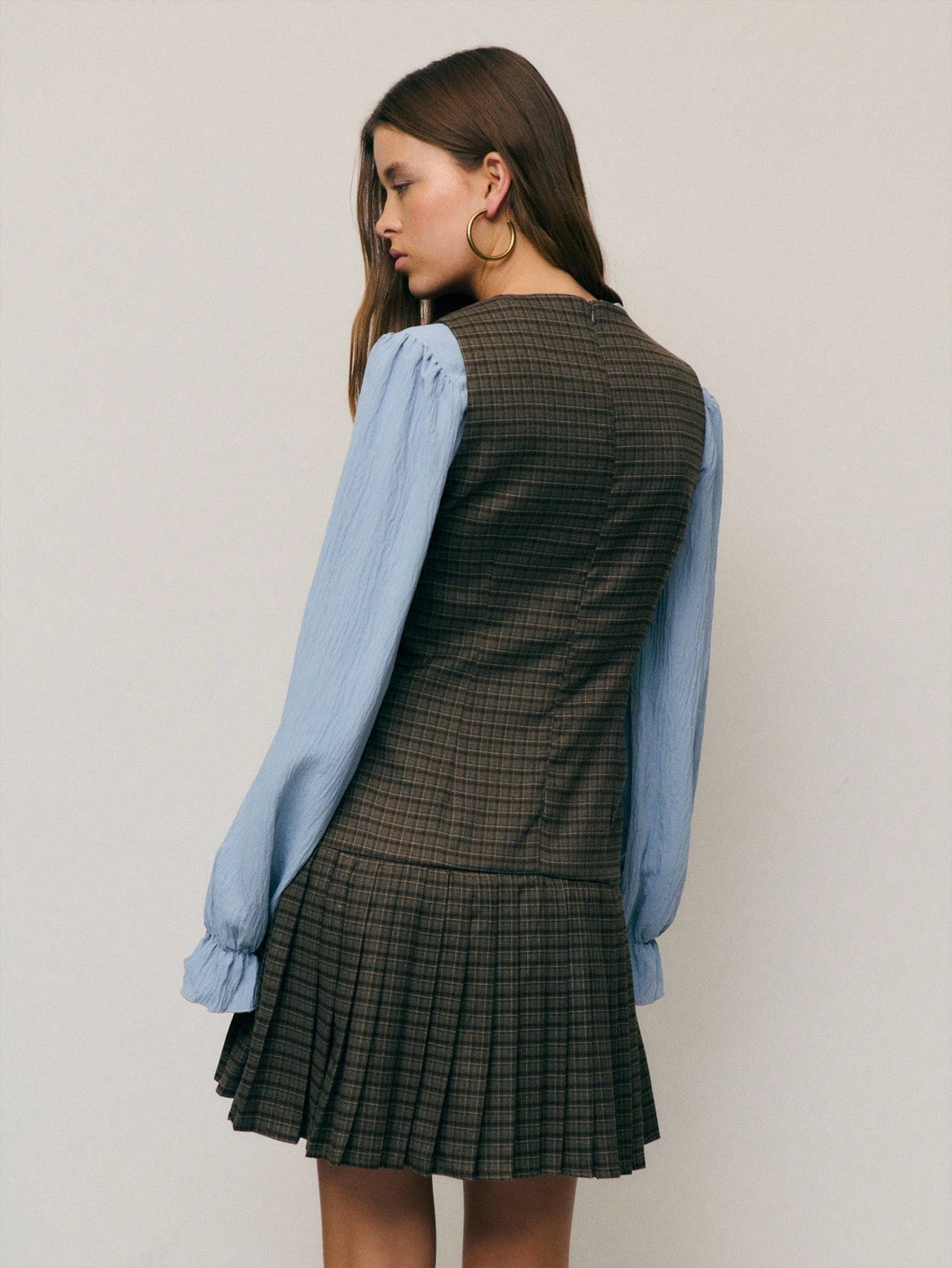 Embrace the season in this charming plaid dress that's basically autumn in fabric form. The pleated hem adds a playful bounce to your step, while the classic plaid pattern works with everything in your closet. Whether you're sipping cider at the farmers market or heading to a casual dinner, this dress delivers effortless style without the fuss. Cozy, cute, and ready for all your fall adventures.