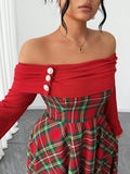 Close-up of off-shoulder red neckline and pearl-look buttons on tartan dress