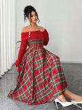 Seated front view of red tartan off-shoulder midi dress styled with white pumps