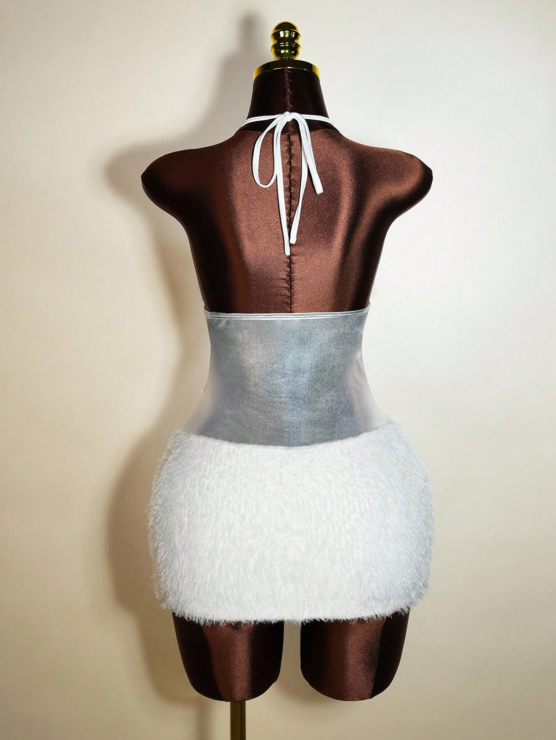 Turn heads effortlessly with this playful wool blend mini dress, featuring shimmering gold foil accents that catch the light with every move. The flirty halter tie adds a touch of charm, making it perfect for lively parties or unforgettable romantic evenings. Cozy yet chic, this dress blends warmth with style for a look that’s as fun as it is elegant.