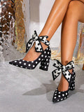 16 media show women polka dot pointed toe pumps in white/black variants with ankle bow wrap or buckle strap, stiletto or chunky block heel, sheer mesh panels on some styles. image 4