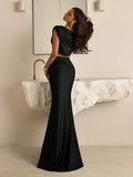 Black draped two-piece evening outfit with exposed midriff