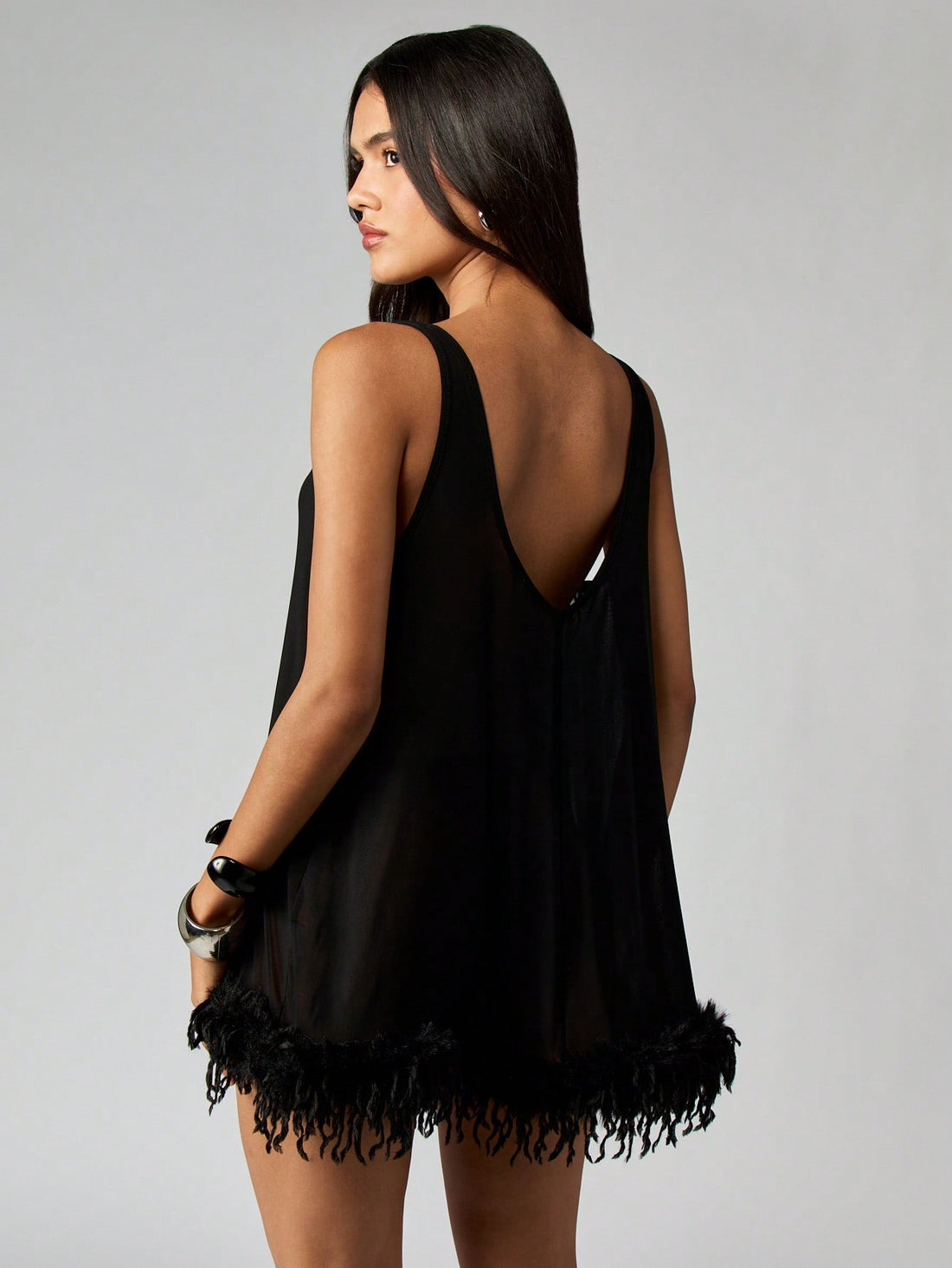 Turn heads with this Elegant Sheer Mini Babydoll Dress featuring delicate feather trim that adds a flirty touch. Its lightweight, sheer fabric lets you feel effortlessly glamorous, making it ideal for parties or a fun night in. Playful and charming, this dress promises to elevate your evening with a dash of whimsy and style.
