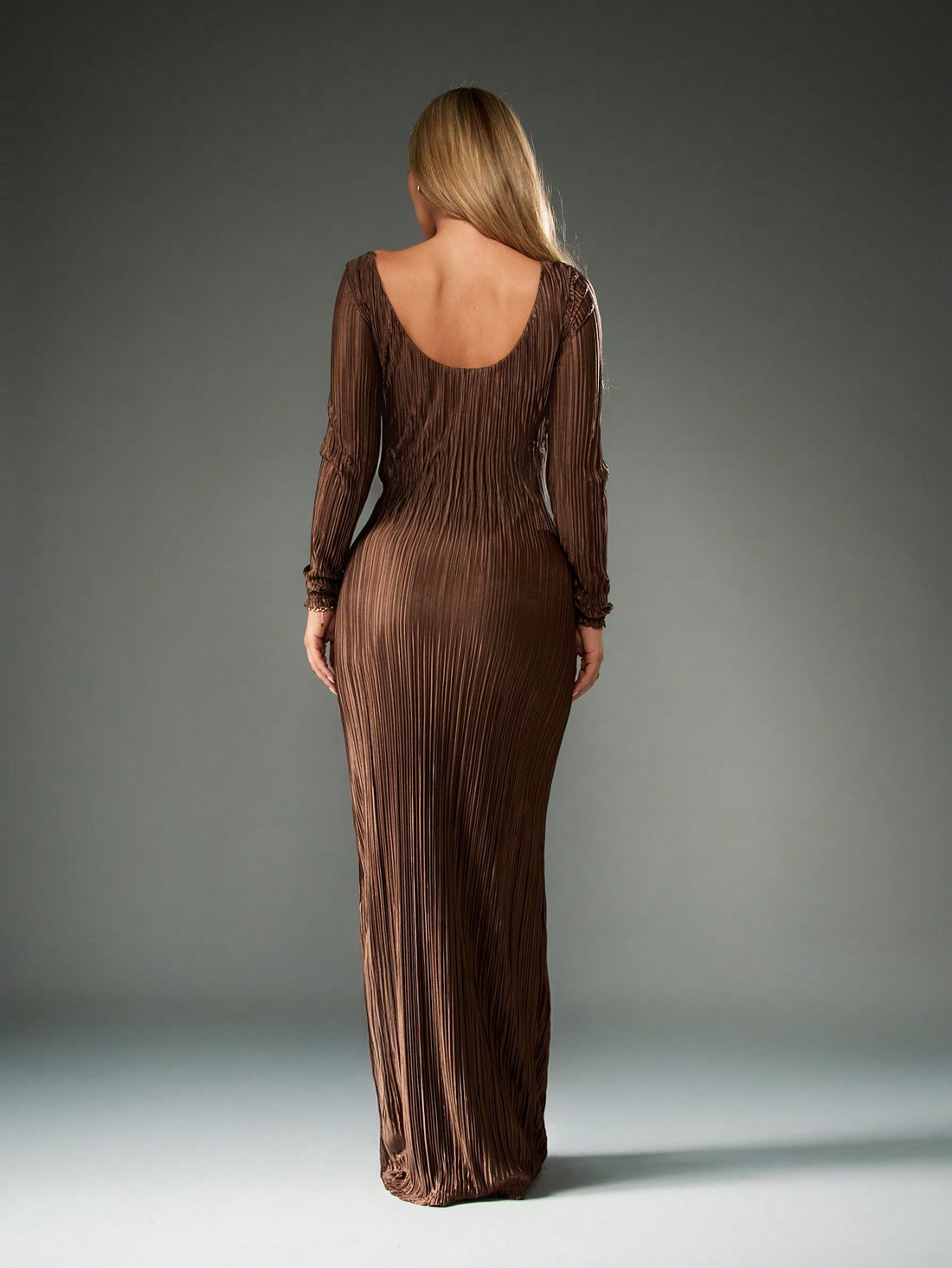 Step into the spotlight with this playful yet elegant long sleeve pleated maxi dress. The ruched bodice adds a flirty twist while flattering your figure, and the floor-length silhouette sweeps gracefully as you move. Perfect for special occasions, this gown offers a blend of sophistication and fun to keep you twirling all night long.