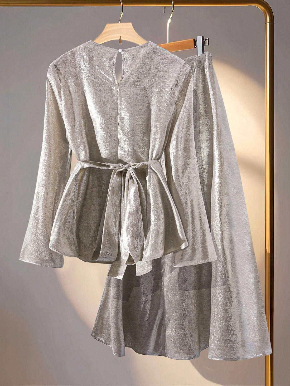 Elevate your cold-weather wardrobe with this show-stopping two-piece set! The asymmetric knotted top catches the light beautifully in shiny silver, while the draped hem midi skirt adds effortless elegance and movement. Perfect for autumn and winter occasions, this dynamic duo works together to create a polished, fashion-forward look that turns heads. Mix, match, or wear as a set—either way, you're guaranteed to shine.