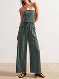 Front view of dark slate green strapless wide-leg jumpsuit with utility patch pockets