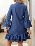 Rear view of blue A-line denim mini dress with bell sleeves and tiered hem